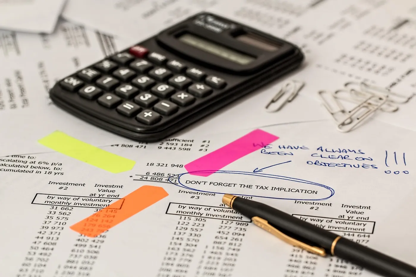 Une calculatrice et des documents administratifs posés sur un bureau